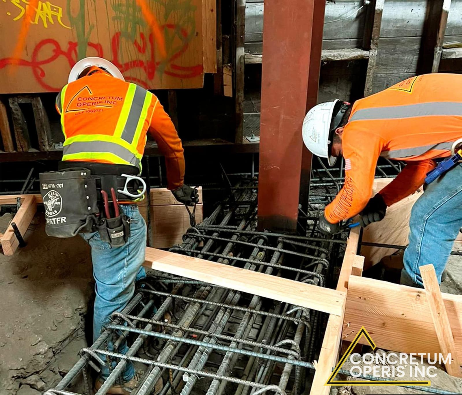 Crew tying a rebar cage around a steel column footing in Richmond, CA