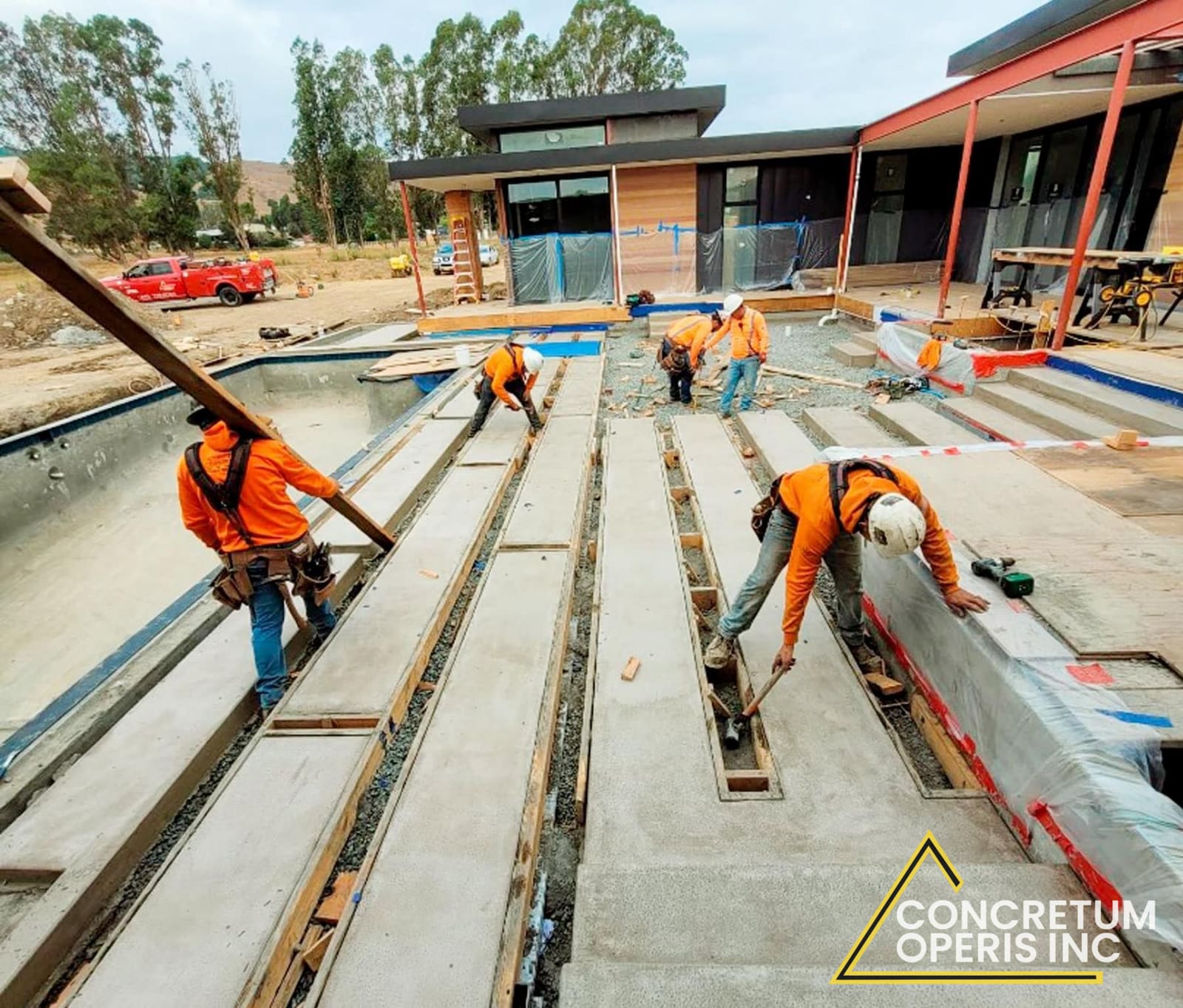 Crew forming concrete deck slabs around a pool foundation in Richmond, CA